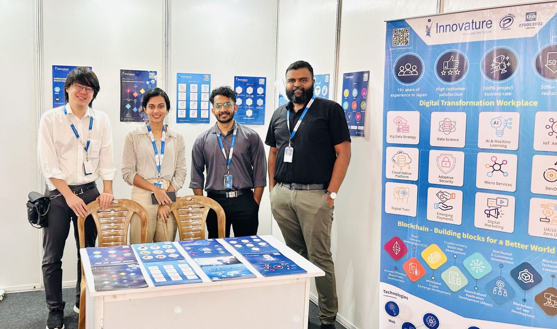 4 Employees from Innovature standing in front of the booth at the Japan Mela 2025